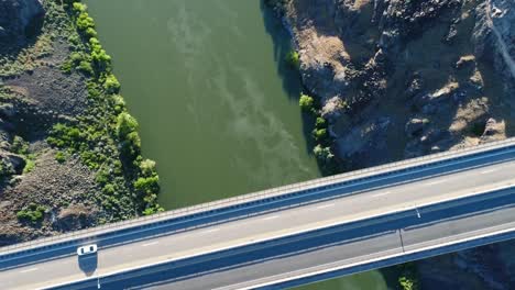 a 4k fly-over drone shot of perrine bridge, a 1,500 foot long bridge, spanning over the snake river in twin falls, idaho