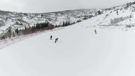 snowboarding down a snowy mountain slope