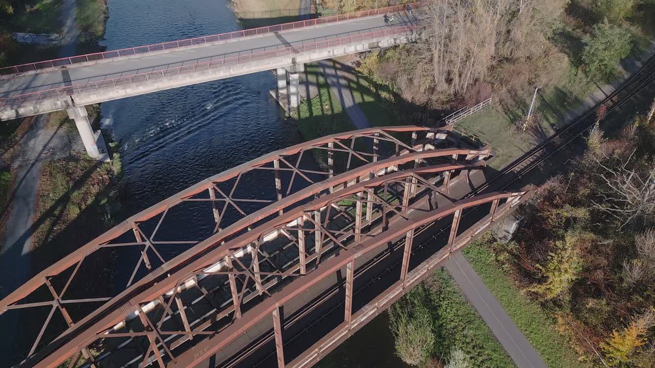 Drone reveals old rusty steel arch railway bridge over River Ostravice