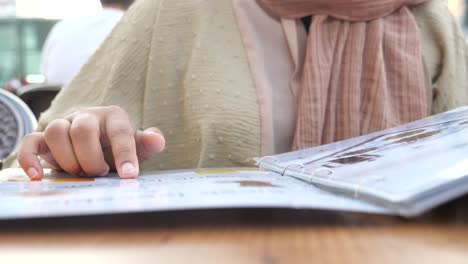 woman reading a restaurant menu