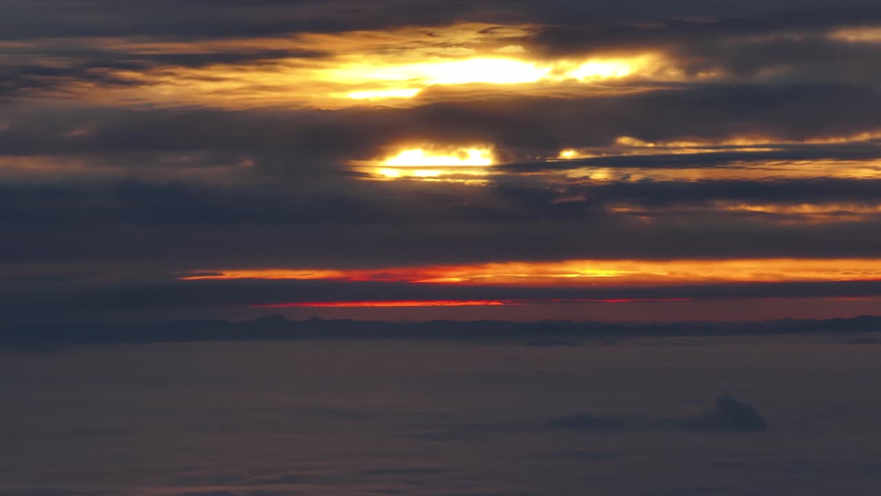 Epic orange sunset through the clouds