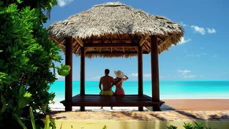 caucasian family outdoors in a tropical beach hut