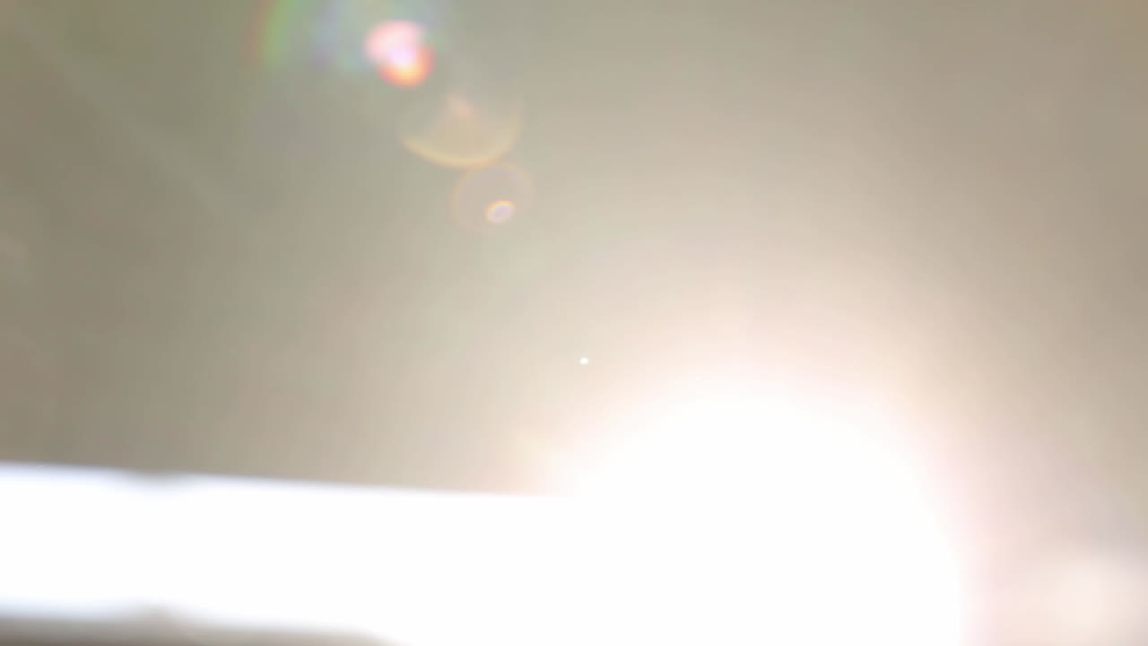 Blurred scene of sunlight coming through window slit. Gimbal, pedestal down