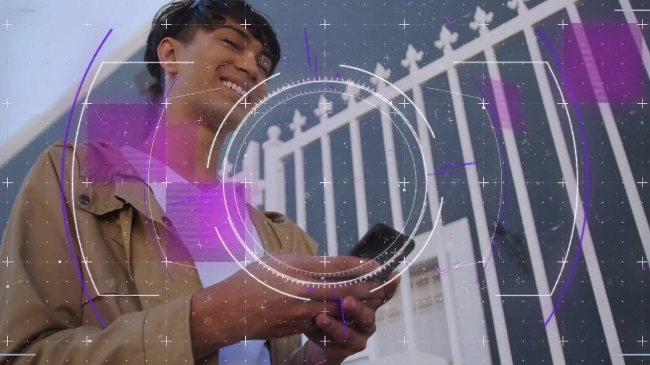 Man standing by building and fence tapping smartphone initiating HUD animation and smiling for tech