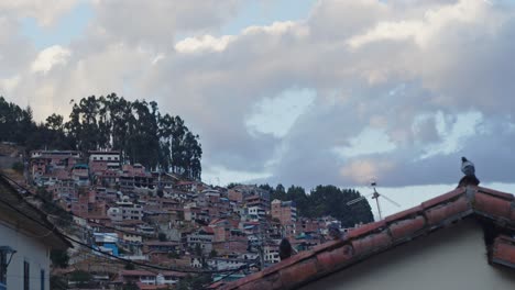 Sunset-Cusco-rooftop-and-homes-on-side-of-andes-mountains---4k