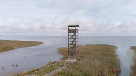 scenic aerial view of estonian lake vortsjarv with watchtower, northern european landscape, circle pan, day