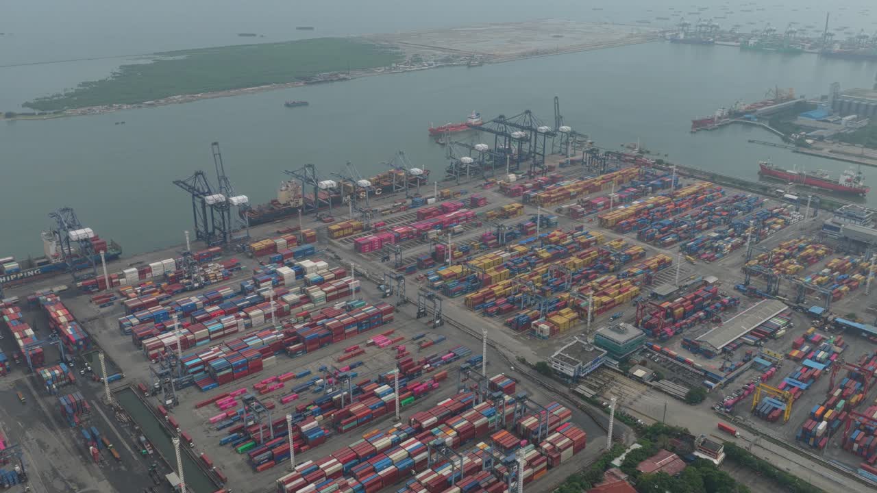 High-angle drone view of cargo terminal and maritime infrastructure in Jakarta