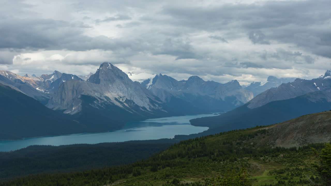 Timelapse of serene Maligne Lake and rugged mountain peaks from Jasper’s Bald Hills on a cloudy day