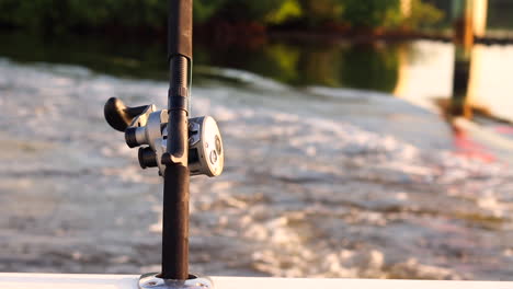 fishing rod in pole holder at sunset