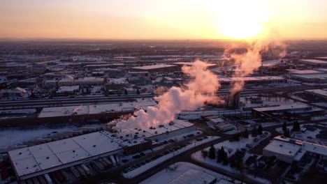 an aerial shot of the steaming factory during sunset