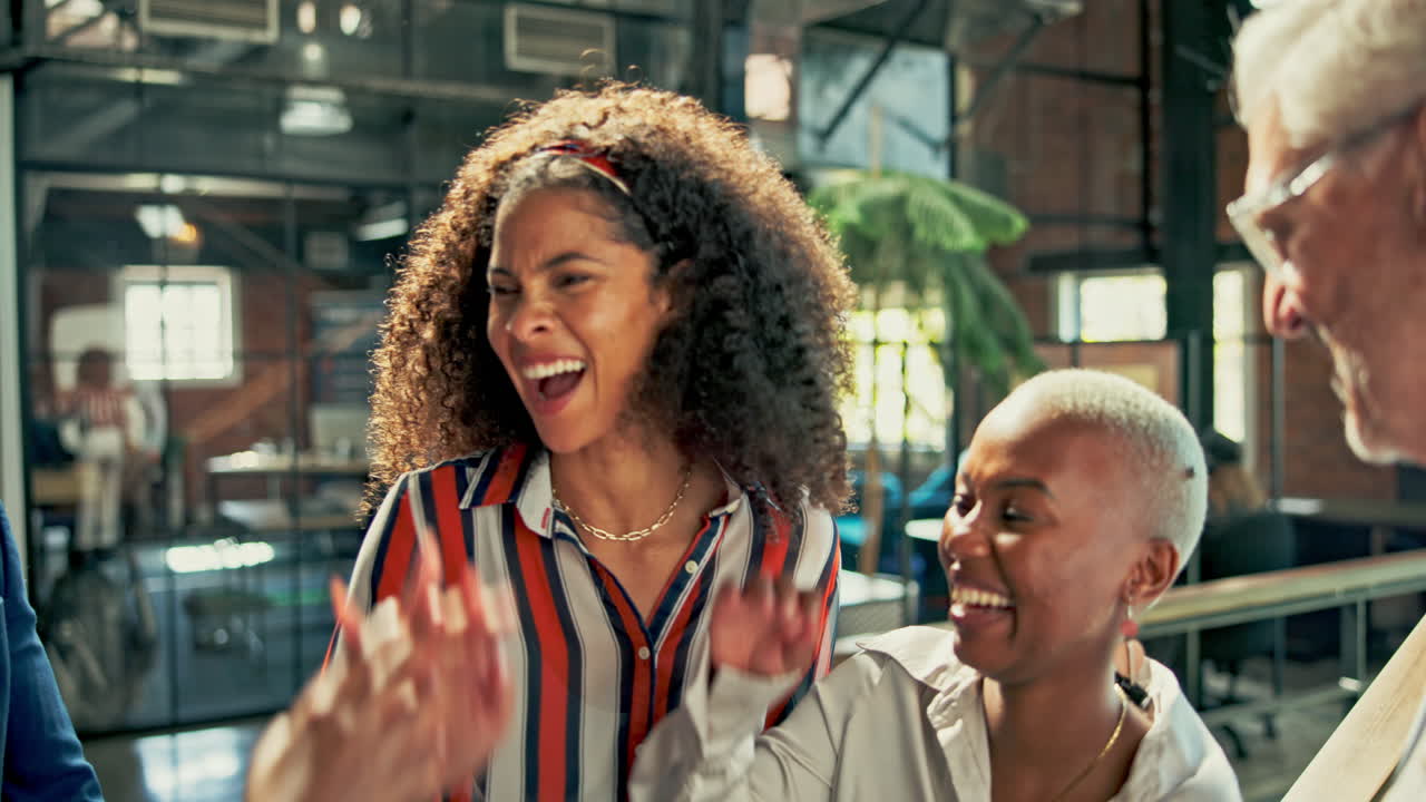 Diverse team celebrating success in modern office