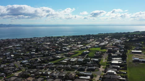 aerial orbital of township housing estates along coastal bay waters