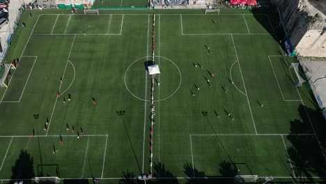 players at soccer field trogir city dalmatian coast - aerial pullback