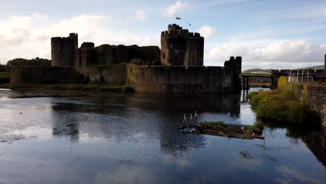 Time-lapse-shot-of-Caerphilly-Castle-during-sunlight-and-clouds,surrounded-by-water-ditch
