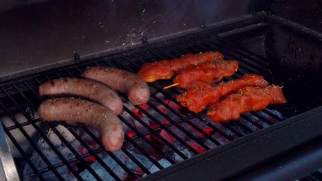 looking at the sausages and chicken sate getting the heat and smoke of the bbq