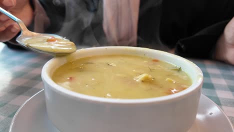 woman eating soup