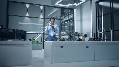 woman celebrating success in modern office with jet engine