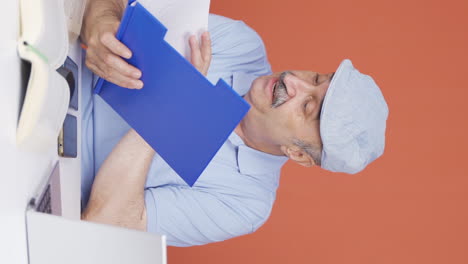 Vertical-video-of-The-old-man-examining-the-files-approves-the-files-with-his-head.