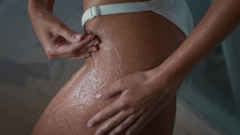 mujer aplicando exfoliante corporal