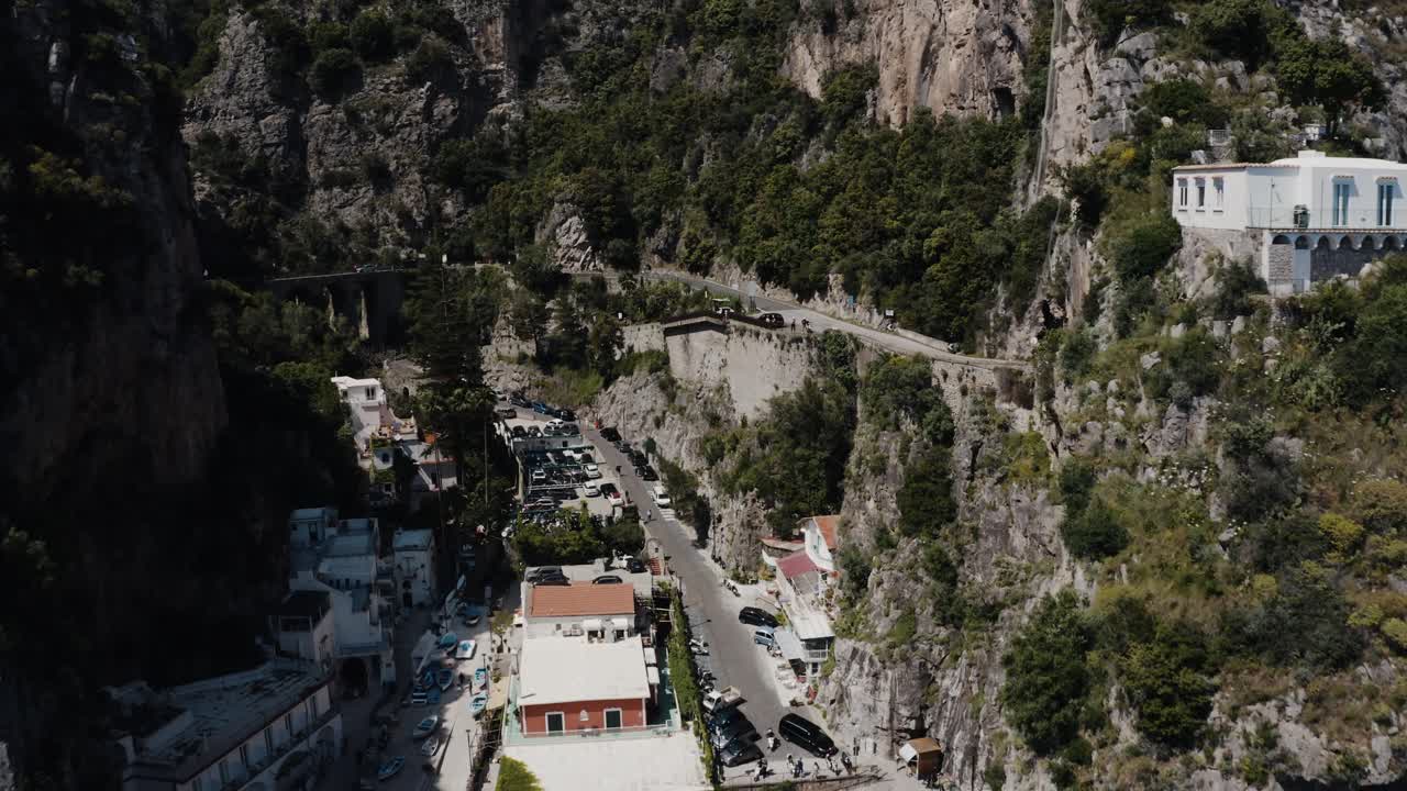 Drone shot pushing through Italy's steep mountains to reveal homes built on steep gradients