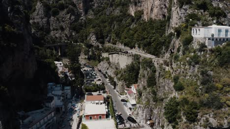 drone shot pushing through italy's steep mountains to reveal homes built on steep gradients