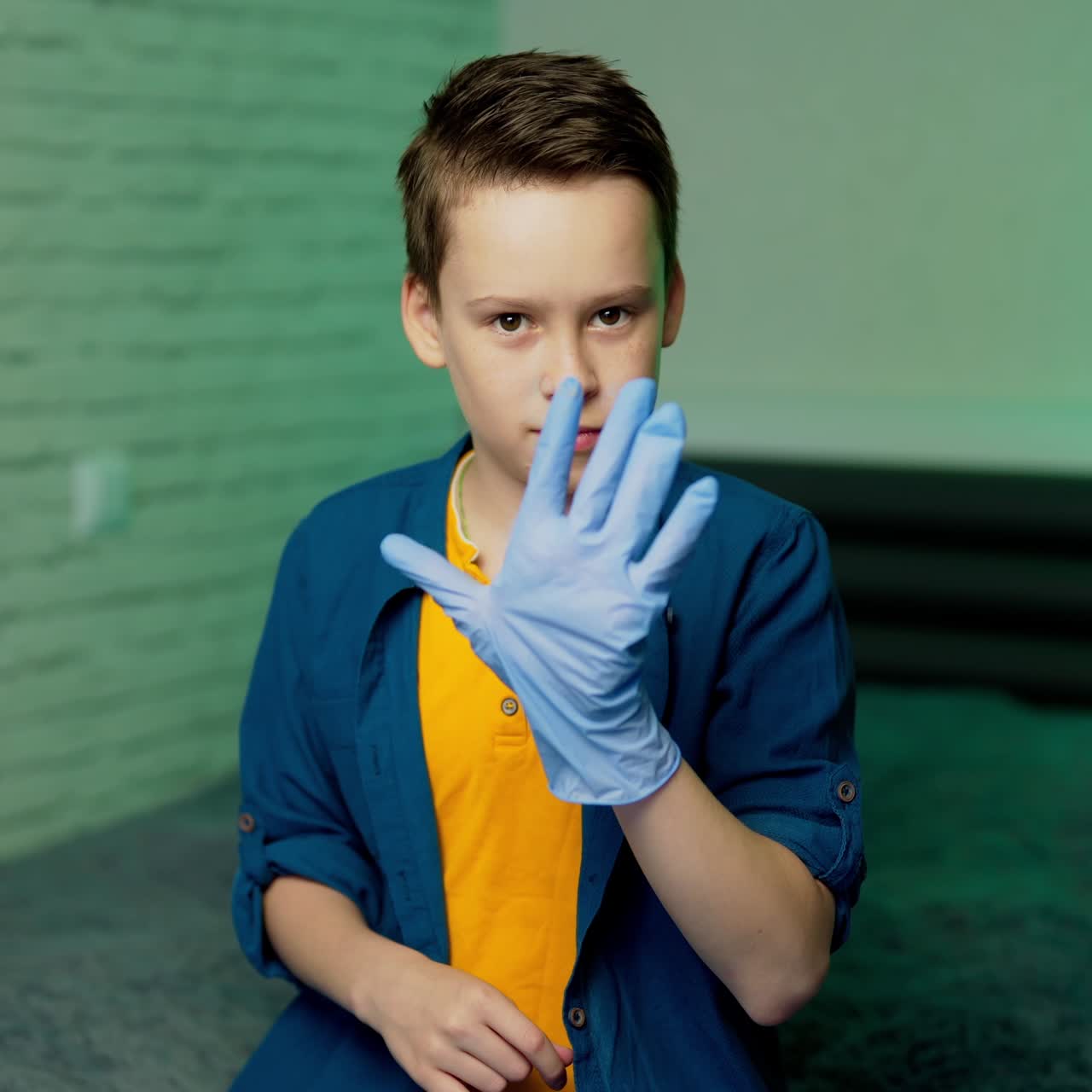 Boy puts on rubber gloves. Stop coronavirus. Pandemic. COVID-19