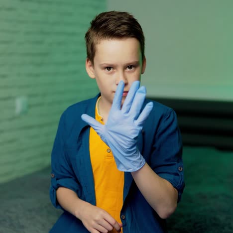 boy puts on rubber gloves. stop coronavirus. pandemic. covid-19