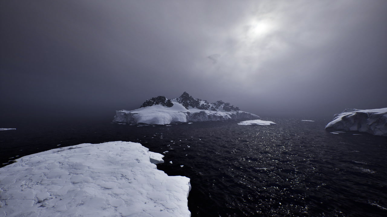Tranquil icy seascape displays distant jagged island cloaked in gentle fog