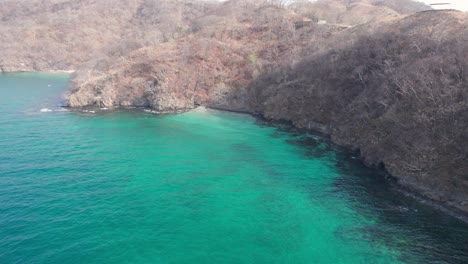 Drone-view-of-the-exotic-turquoise-Playa-Penca-beach-in-Guanacaste,-Costa-Rica