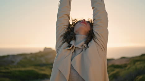 curly woman evening sunlight stretching vertical closeup. thoughtful girl admire