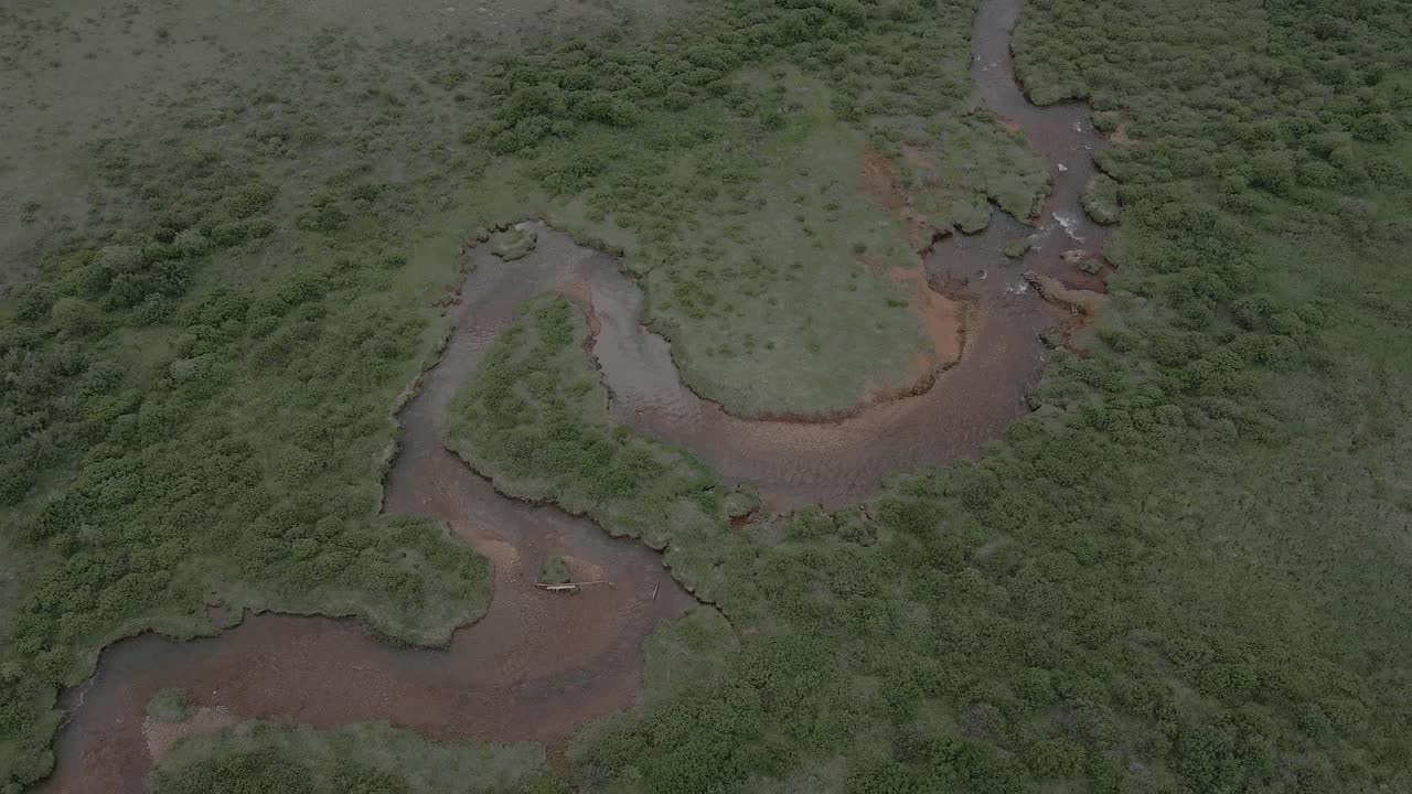Aerial View of a Meandering River Surrounded by Lush Vegetation