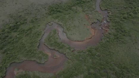 aerial view of a meandering river surrounded by lush vegetation