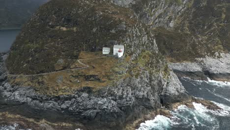 drone shot of hendanes lighthouse in måløy slowly revealing beautiful nature