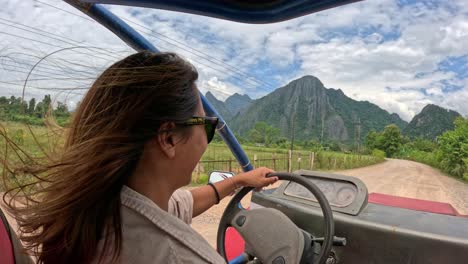 female buggy driving, laos vang vieng, tourist excursion, point of view