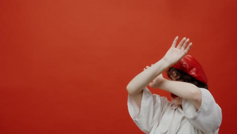 woman in red beret and white shirt, studio portrait