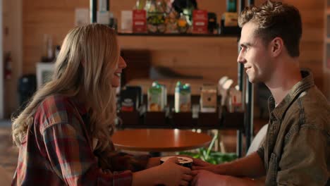 Young-couple-interacting-with-each-other-in-cafe-4k