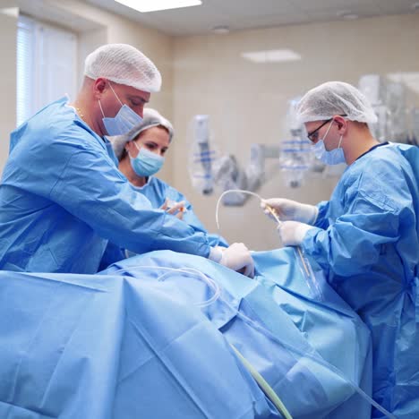 process of endoscopic surgery operation. group of surgeons in the operating room use medical equipment. modern surgery room in clinic.