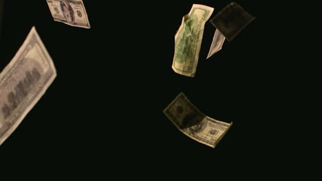 dollar bills falling on black background