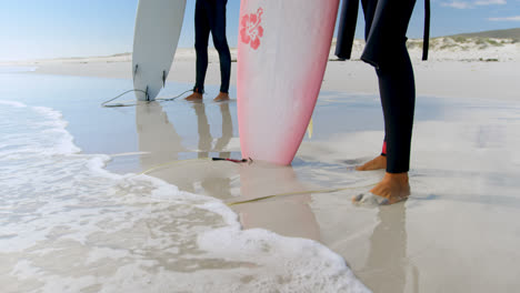 couple with surfboards looking at the sea 4k