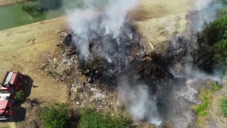 Aerial-view-of-a-structure-fire,-smoke-rising-from-a-building-in-flames-cloudy-day,-Arson-in-Mexico-city---orbit,-drone-shot