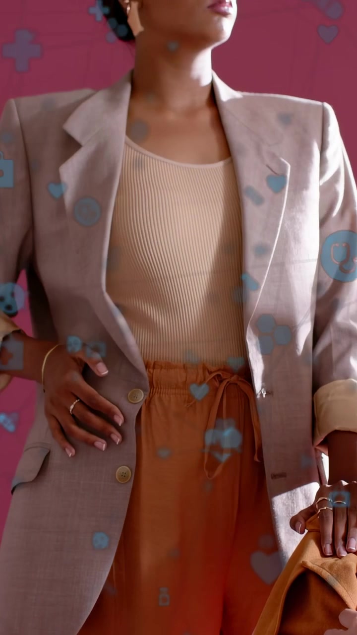 Vertical video: Cam up model fixing blazer showing rust pants while blue icons floating for fashion