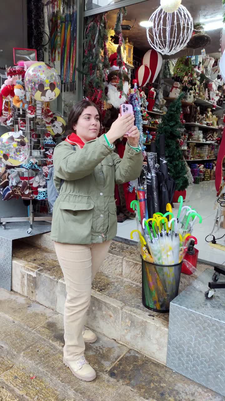 A woman is taking a picture of a display of umbrellas