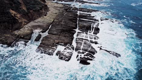 dramatic ocean cliffs on the west coast with waves crashing against rocks