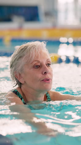 senior woman swimming in a pool