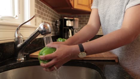 Woman-Washing-Vegetable-in-the-Sink-to-Prepare-to-Chop