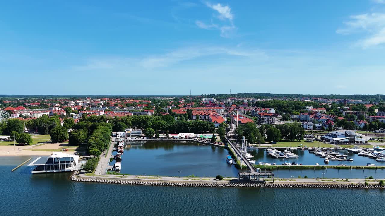 Gizycko city marina and skyline, aerial side fly view