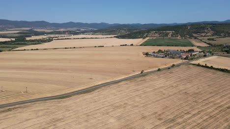 aerial view panning left across large farms and fields in slovakia