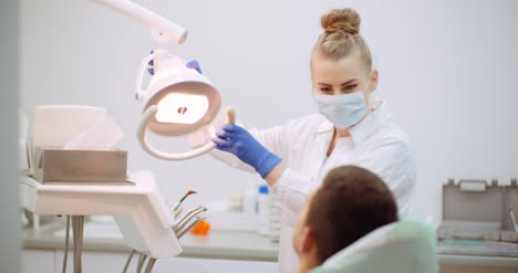 female dentist treats patient at dental clinic 1