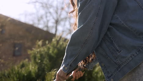 close-up view of caucasian woman pruning the plants in the countryside