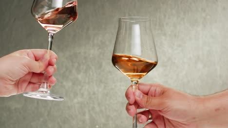 rose orange or white wine bottle and glass against a sunset in a peaceful vineyard, pouring of ecological natural wine. cheers, hands with wine glasses, drinking alcohol.